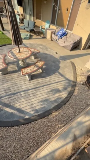 Circular paver patio laid around a central fire feature in Orange County, California