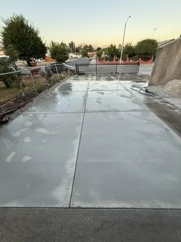 Freshly poured concrete slab with a broom finish and tooled control joints in Orange County, California